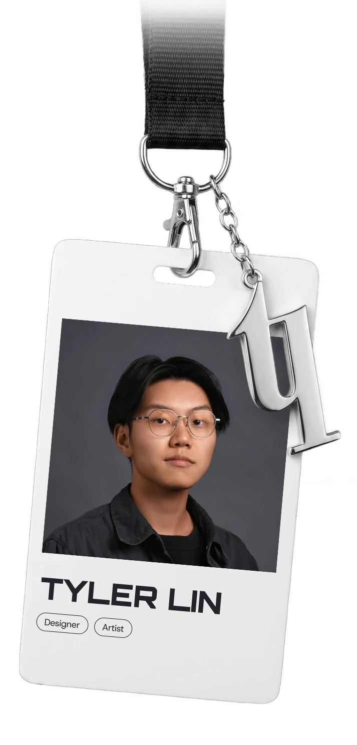 Tyler's photo ID badge on a lanyard, with a logo-shaped keychain charm.