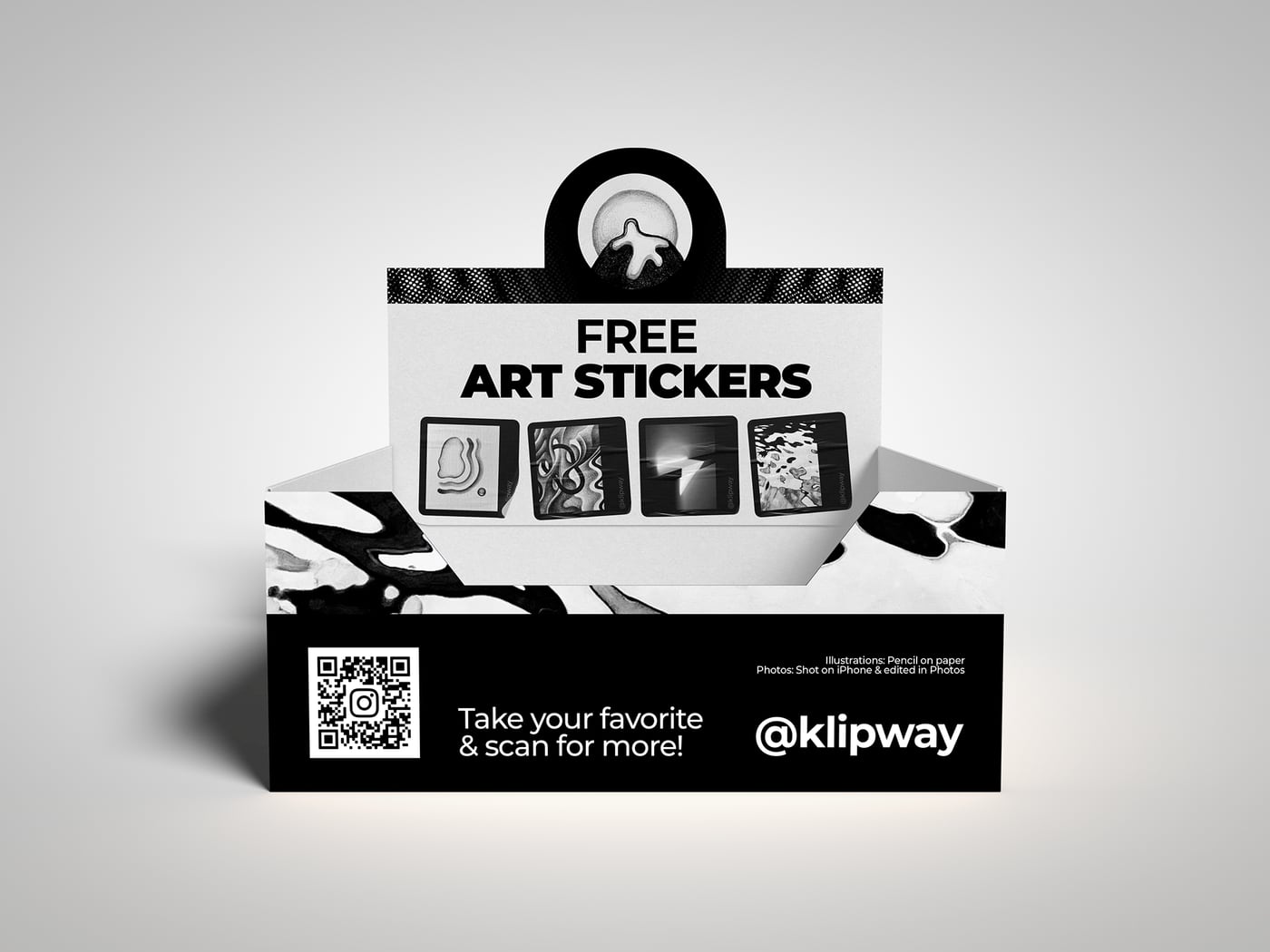 A countertop display box reading Free Art Stickers, filled with black-and-white sticker prints, a QR code on the front panel.
